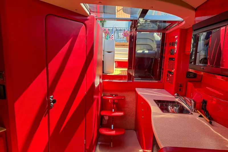 Slide: The Image of Interior of 2002 Hallett Custom High Performance Express Cruiser with vibrant red cabinetry. - 16