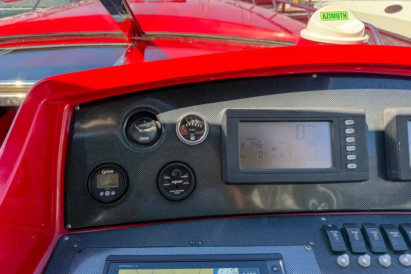 Slide: The Image of Dashboard of a 2002 Hallett Custom High Performance Express Cruiser with gauges and controls. - 24