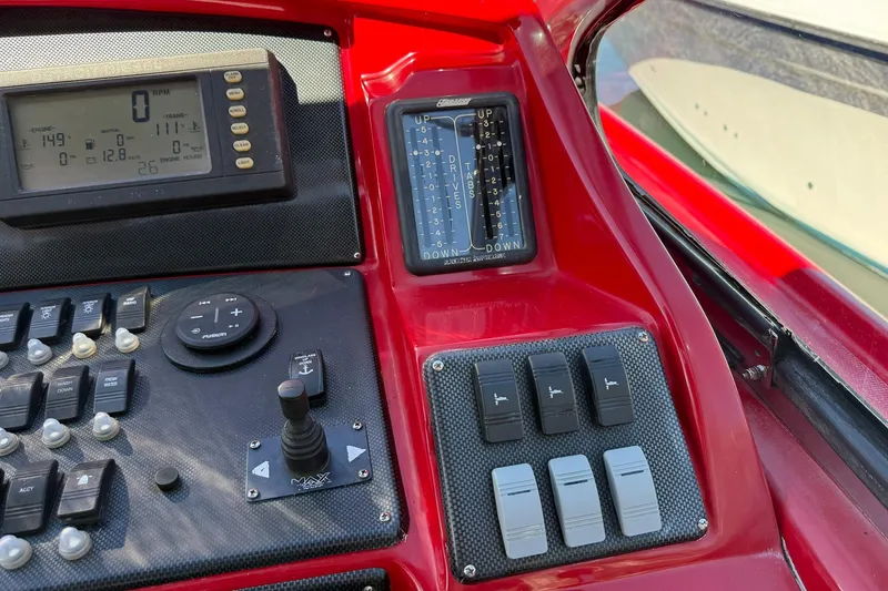 Slide: The Image of Control panel of a 2002 Hallett Custom High Performance Express Cruiser boat. - 25