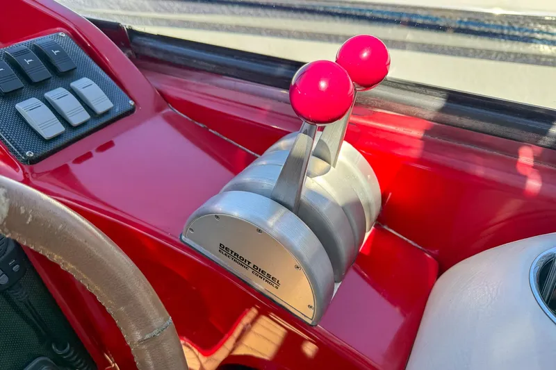 Slide: The Image of Throttle controls on a 2002 Hallett Custom High Performance Express Cruiser, featuring red levers. - 26