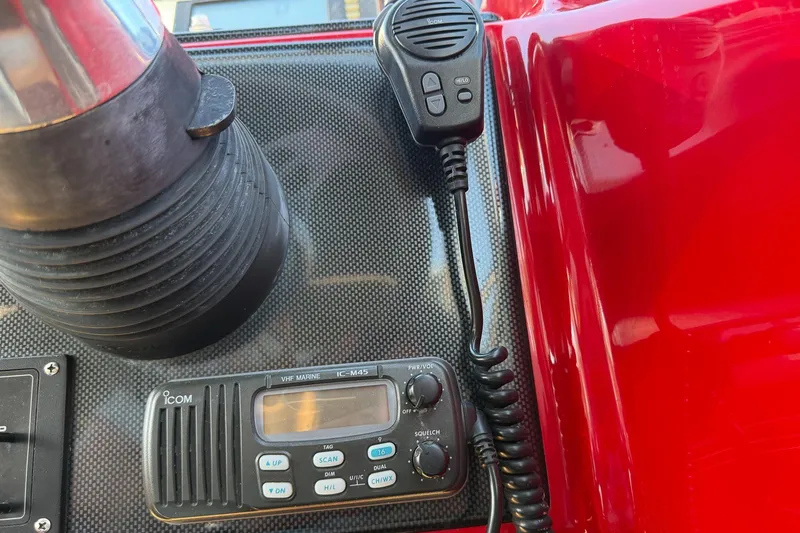 Slide: The Image of VHF marine radio and microphone on 2002 Hallett Express Cruiser dashboard. - 28