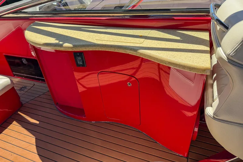 Slide: The Image of Red interior of 2002 Hallett Express Cruiser with beige countertop and wooden flooring. - 32
