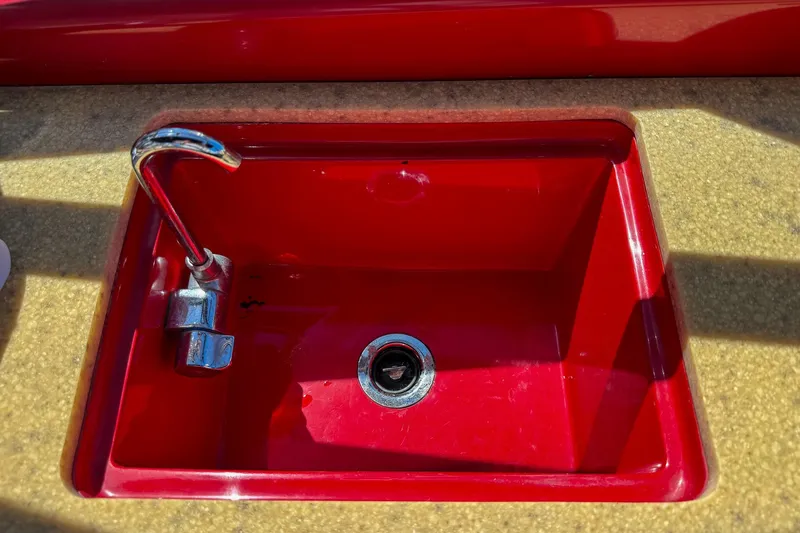 Slide: The Image of Red sink with chrome faucet on Hallett 2002 Custom High Performance Express Cruiser. - 33
