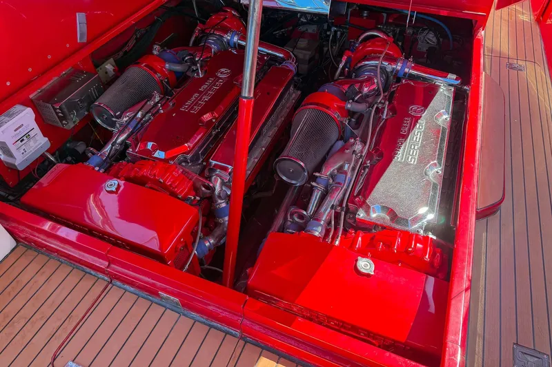 Slide: The Image of Engine compartment of a 2002 Hallett Custom High Performance Express Cruiser, featuring vibrant red components. - 36