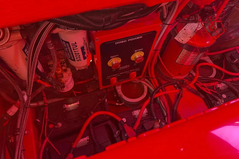 Slide: The Image of Engine compartment of a 2002 Hallett Custom High Performance Express Cruiser with wiring and components. - 38