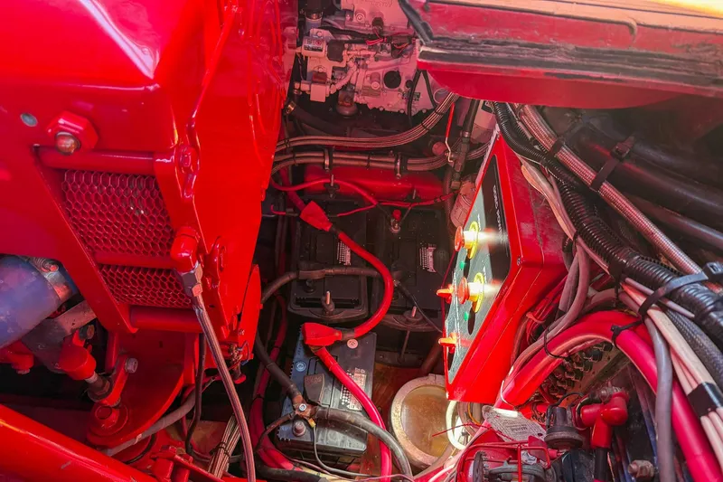 Slide: The Image of Engine compartment of a 2002 Hallett Custom High Performance Express Cruiser, showcasing wiring and components. - 41