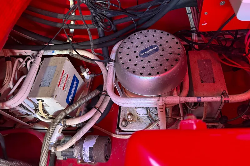 Slide: The Image of Engine compartment of a 2002 Hallett Custom High Performance Express Cruiser with wiring and components. - 42