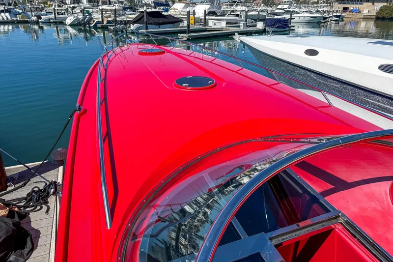 Slide: The Image of Bright red 2002 Hallett Custom High Performance Express Cruiser docked at marina. - 45