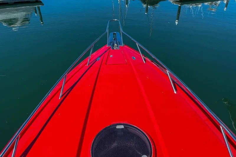 Slide: The Image of Red 2002 Hallett Custom High Performance Express Cruiser on calm water. - 46