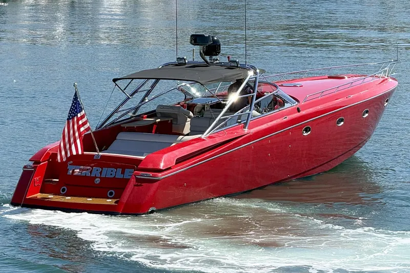 Slide: The Image of Red 2002 Hallett Custom High Performance Express Cruiser on water, American flag displayed. - 54