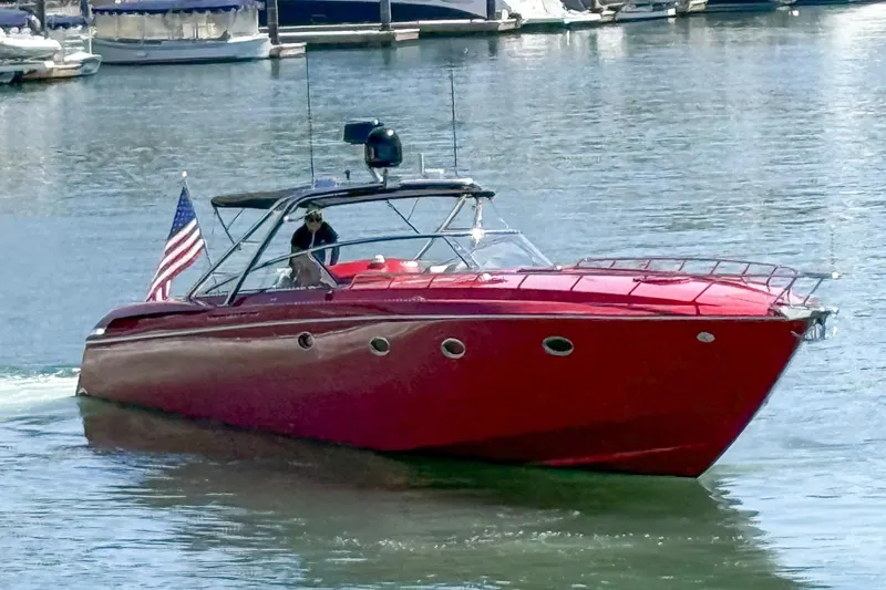 Slide: The Image of Red 2002 Hallett Custom High Performance Express Cruiser on water with American flag. - 58