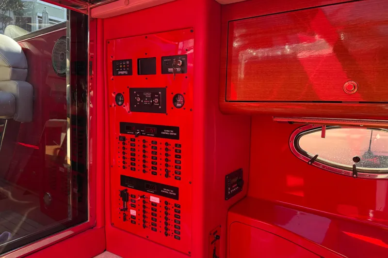 Slide: The Image of Red interior of a 2002 Hallett Custom High Performance Express Cruiser with control panels. - 62
