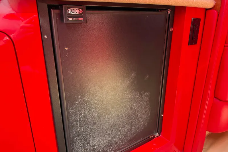 Slide: The Image of Red interior of a 2002 Hallett Express Cruiser featuring a Tundra fridge. - 65