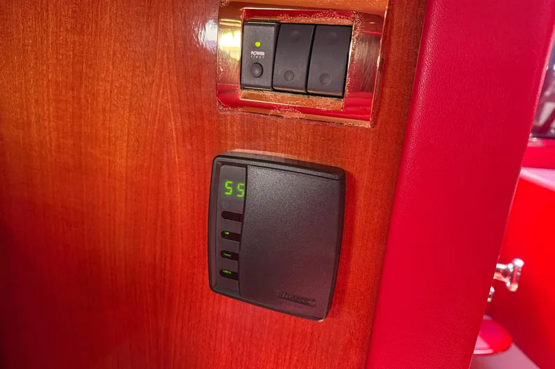 Slide: The Image of Control panel on 2002 Hallett Custom High Performance Express Cruiser, featuring digital display and switches. - 68