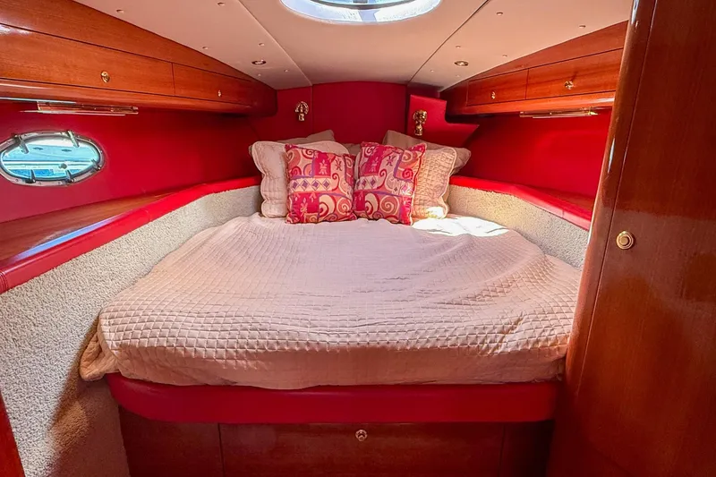 Slide: The Image of Luxurious cabin interior of 2002 Hallett Express Cruiser with plush bedding and vibrant decor. - 9
