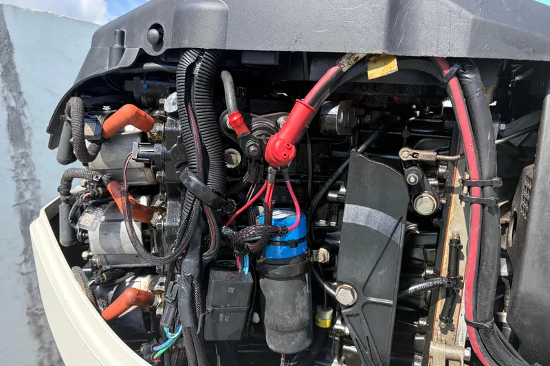 Slide: The Image of Close-up of a 1997 Dusky 256 CC boat engine with visible wiring and components. - 14