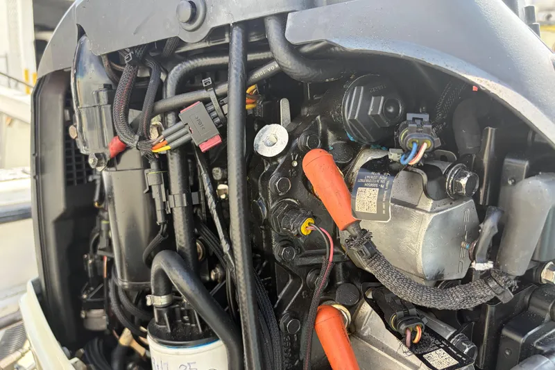 Slide: The Image of Close-up of a 1997 Dusky 256 CC boat engine, showcasing wiring and components. - 10