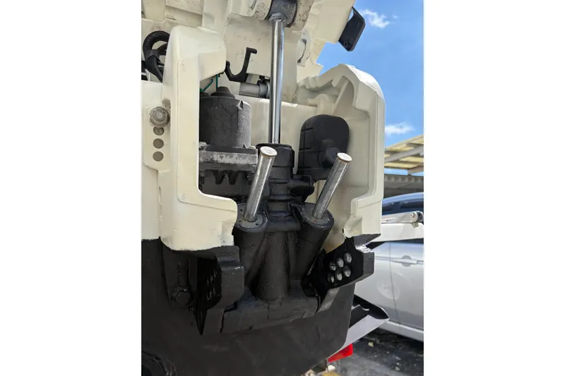 Slide: The Image of Close-up of a 1997 Dusky 256 CC boat engine components under a clear sky. - 11