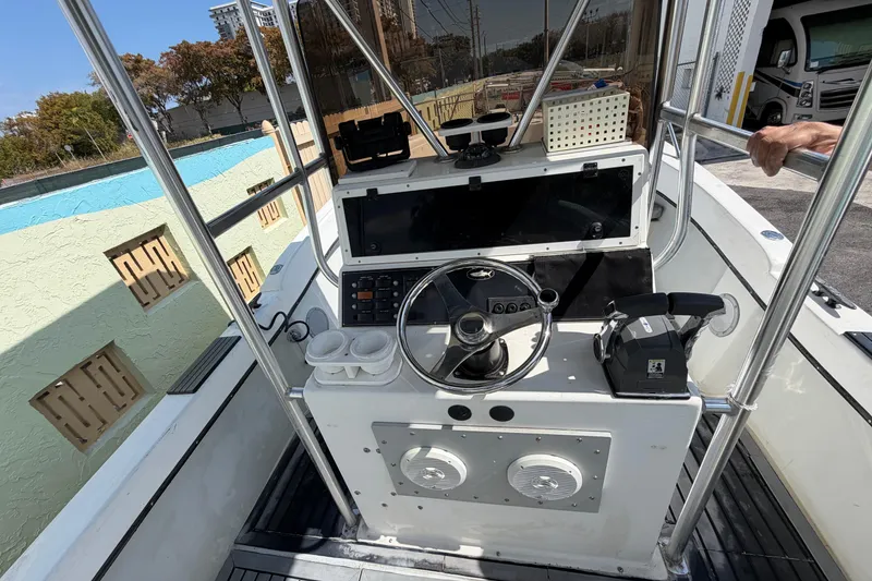 Slide: The Image of 1997 Dusky 256 CC boat console with steering wheel and controls. - 23