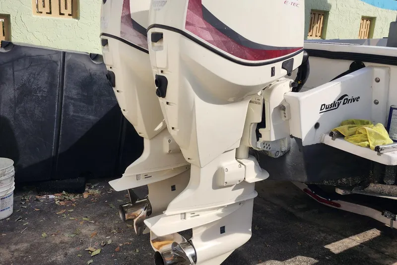 Slide: The Image of Twin outboard motors on a 1997 Dusky 256 CC boat, featuring Dusky Drive system. - 5