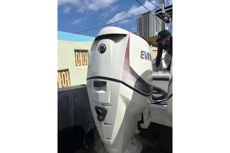 Slide: The Image of 1997 Dusky 256 CC boat with Evinrude outboard motor, urban background. - 7