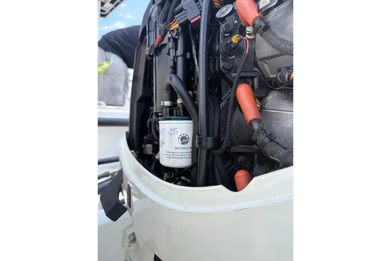 Slide: The Image of Close-up of a 1997 Dusky 256 CC boat engine with visible fuel filter. - 9