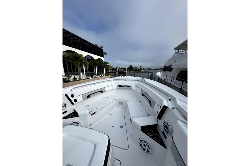 Slide: The Image of 2026 Blackfin 332 CC boat interior with sleek design and modern features at a marina. - 11