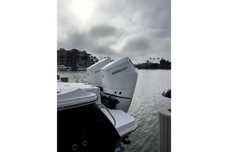 Slide: The Image of 2026 Blackfin 332 CC boat with Mercury engines docked by waterfront. - 13