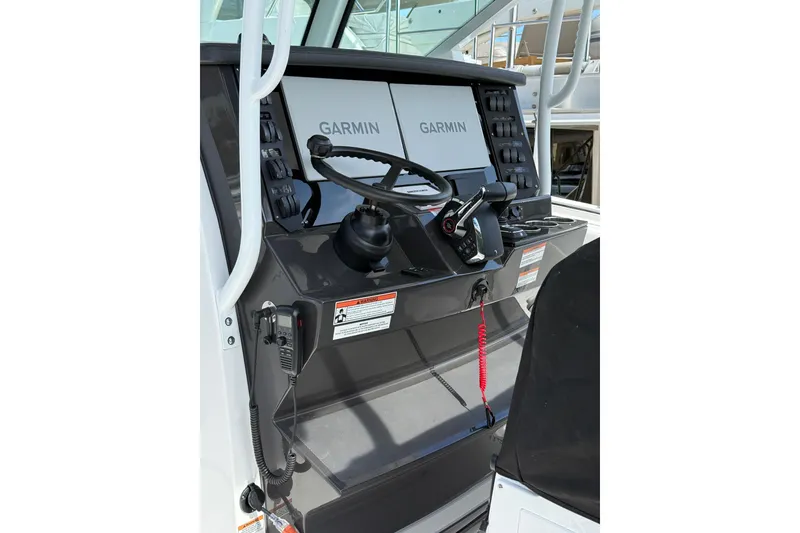 Slide: The Image of 2026 Blackfin 332 CC boat helm with Garmin navigation system and controls. - 14