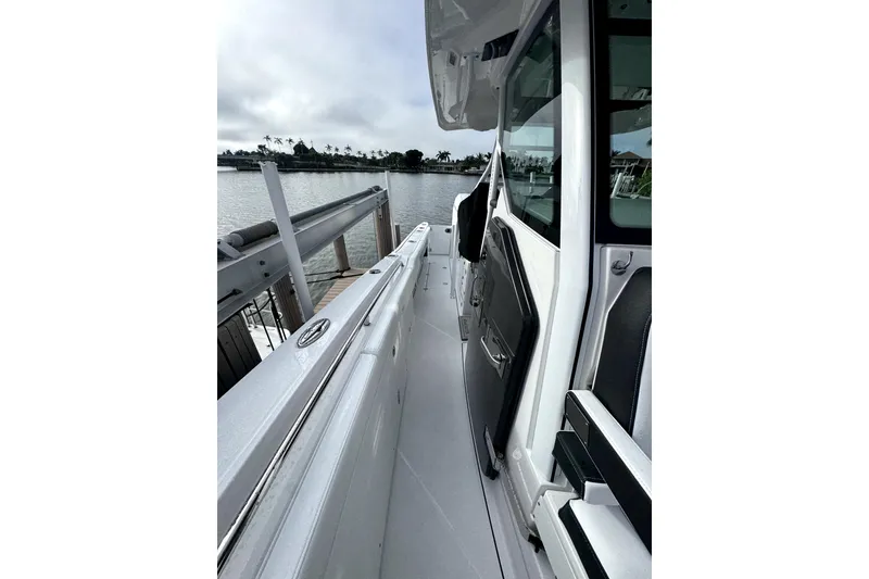 Slide: The Image of 2026 Blackfin 332 CC boat docked, showcasing sleek design and modern features. - 9