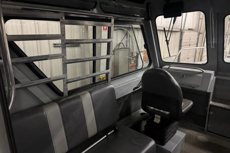 Slide: The Image of Interior of a 2019 Hewescraft 220 Ocean Pro ET Hard Top boat, featuring seating and windows. - 21