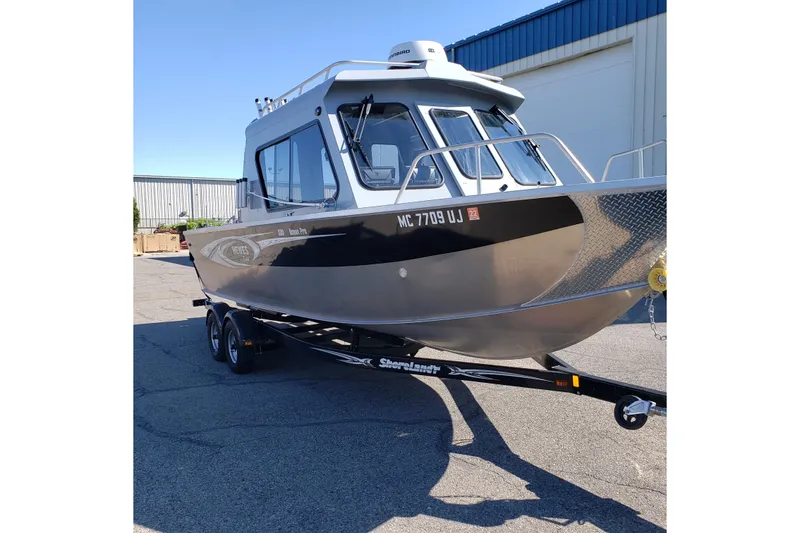 Slide: The Image of 2019 Hewescraft 220 Ocean Pro ET Hardtop boat on trailer, parked outdoors. - 11