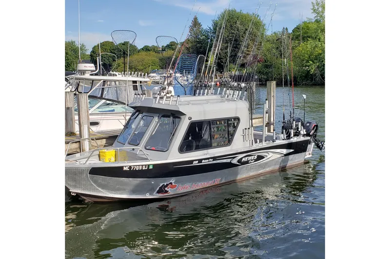 Slide: The Image of 2019 Hewescraft 220 Ocean Pro ET Hardtop fishing boat docked with fishing gear. - 4