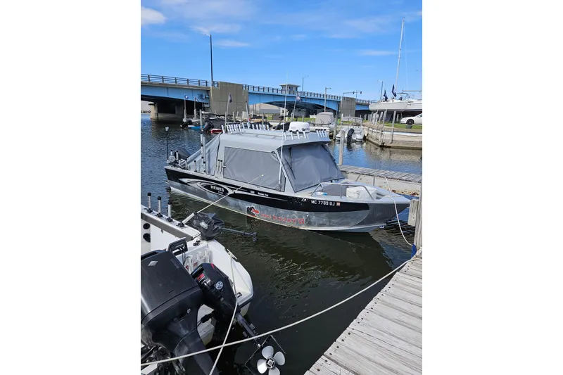 Slide: The Image of 2019 Hewescraft 220 Ocean Pro ET Hardtop docked near a bridge. - 5