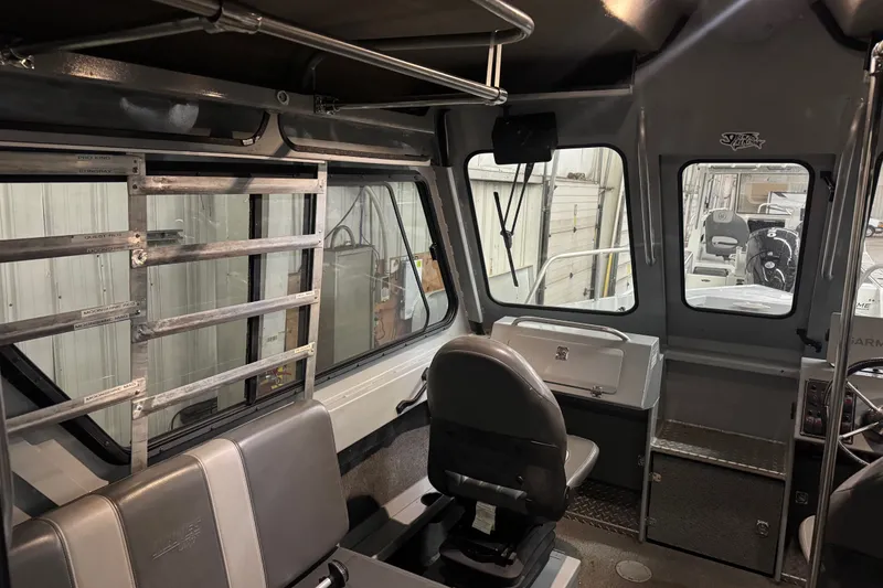 Slide: The Image of Interior of a 2019 Hewescraft 220 Ocean Pro ET Hard Top boat, showcasing seating and controls. - 29