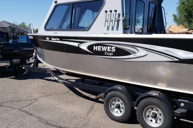 Slide: The Image of 2019 Hewescraft 220 Ocean Pro ET Hardtop boat on trailer, parked outdoors. - 6