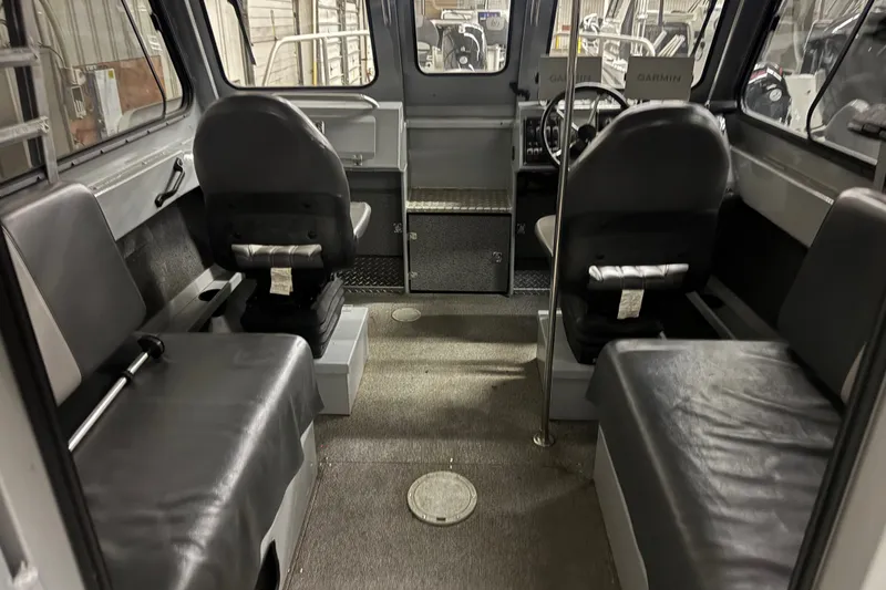 Slide: The Image of Interior of 2019 Hewescraft 220 Ocean Pro ET Hard Top, featuring seating and steering area. - 23