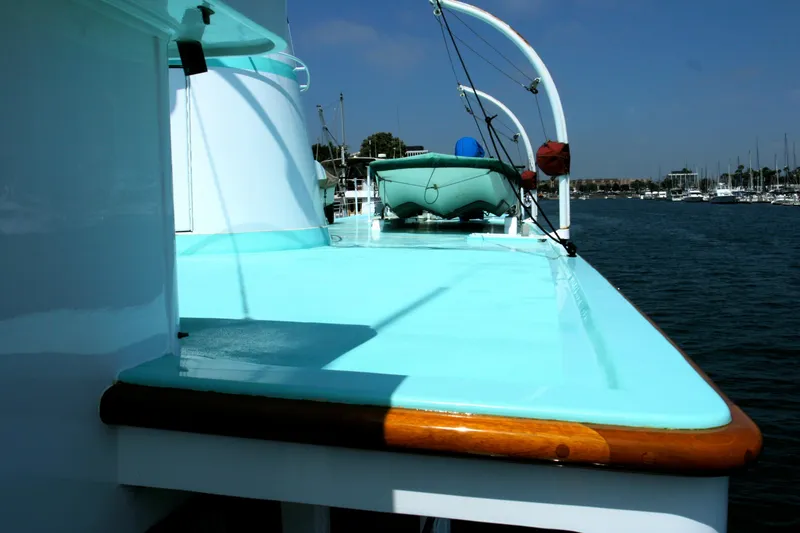 Slide: The Image of 1946 J.M. Martinac yacht with turquoise deck in harbor. - 15