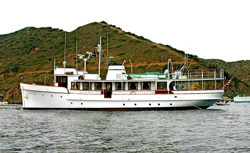 Slide: The Image of Classic 1946 J.M. Martinac motor yacht near an island. - 2