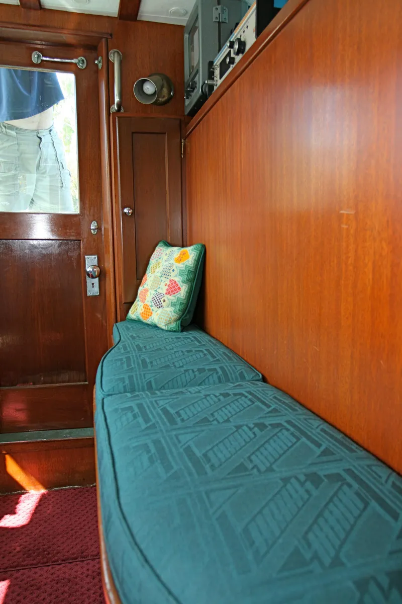 Slide: The Image of Interior of classic yacht with wooden walls and cushioned bench seating. - 20