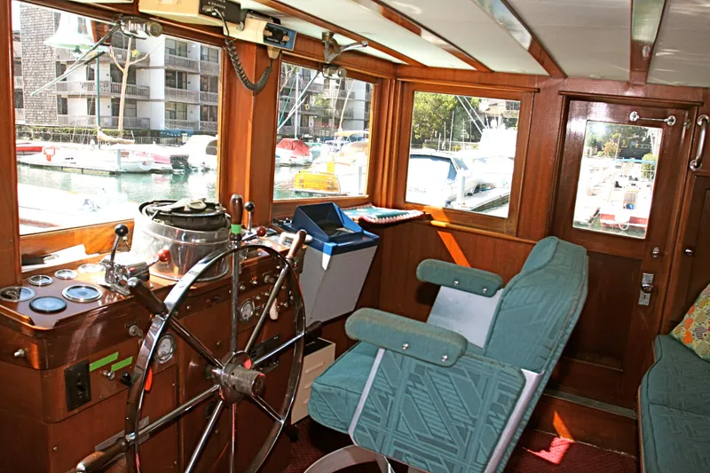Slide: The Image of Interior of a 1946 J.M. Martinac classic yacht with steering wheel. - 21