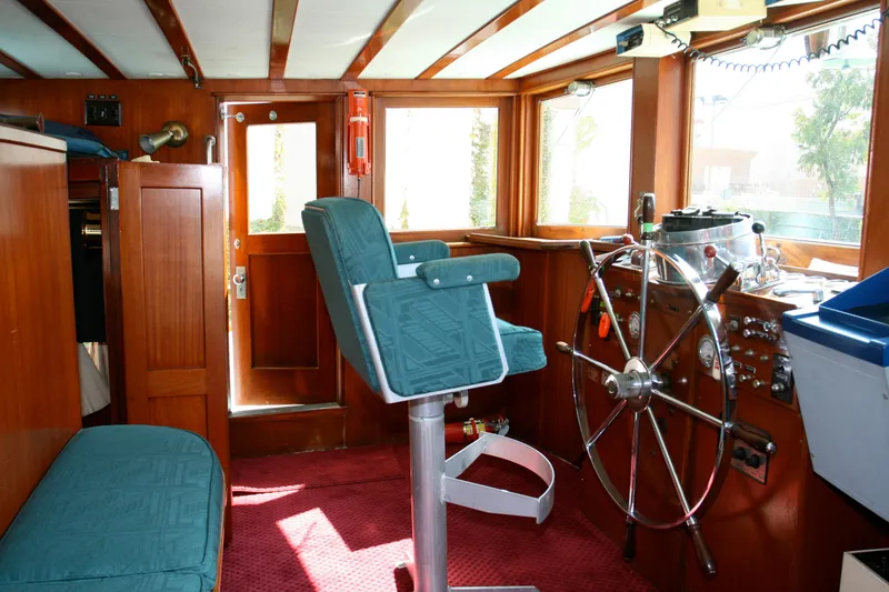 Slide: The Image of Interior of a classic yacht with steering wheel and seat, built in 1946. - 22