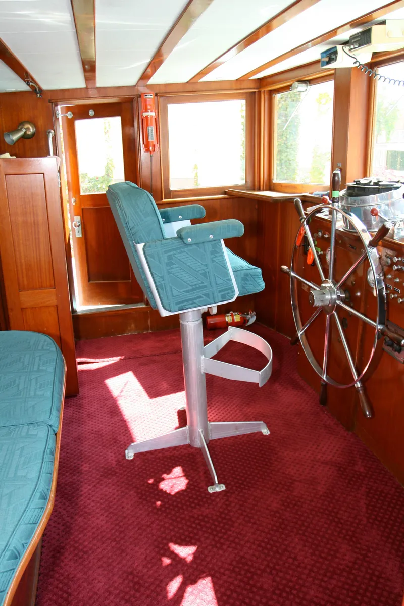 Slide: The Image of Interior of classic yacht with steering wheel and captain's chair, built in 1946. - 23