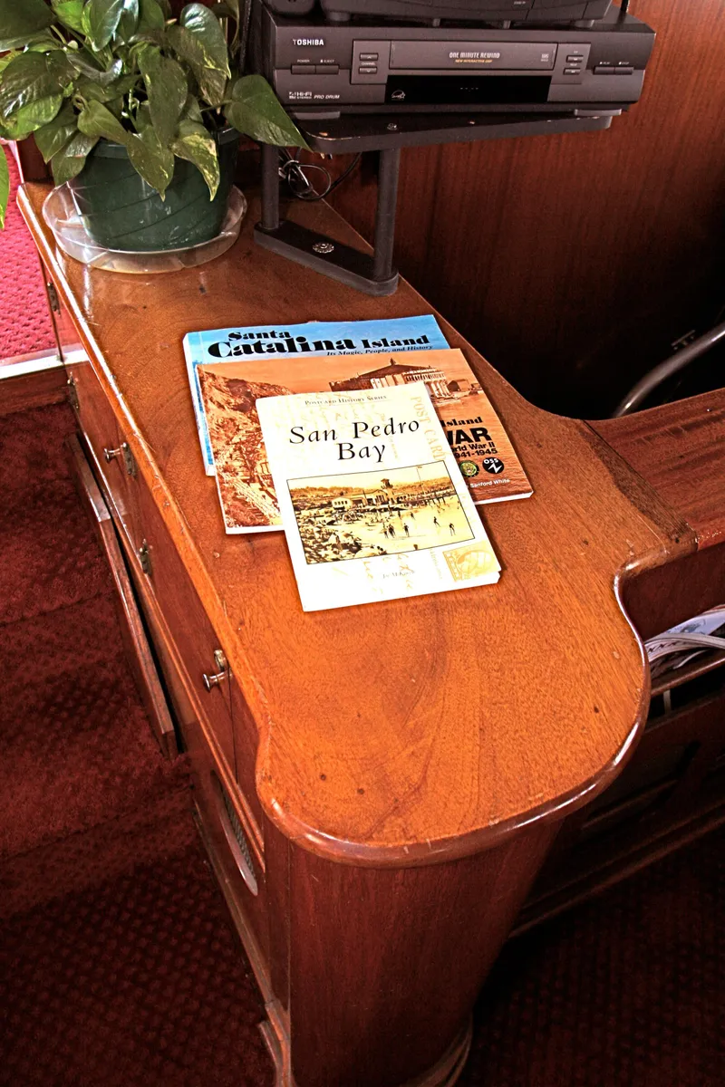 Slide: The Image of Wooden table with books and plant on a 1946 yacht. - 25