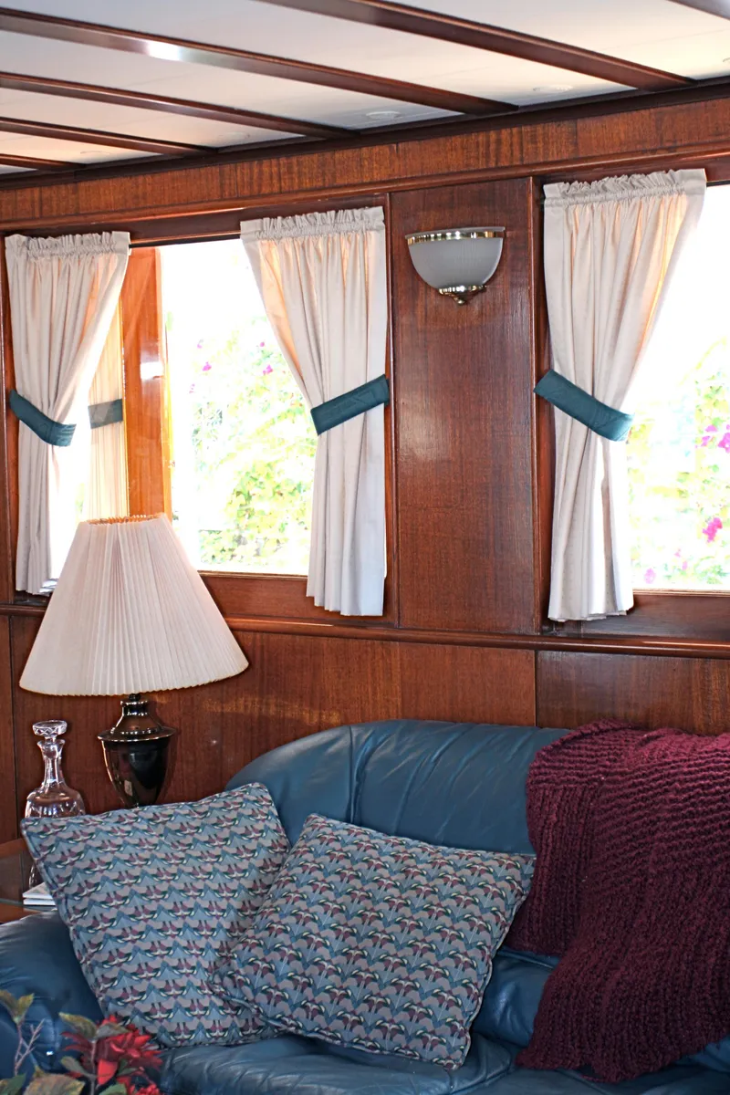 Slide: The Image of Interior of classic yacht with wood paneling and blue accents. - 28