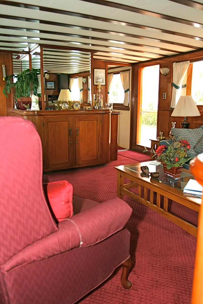 Slide: The Image of Interior of a classic yacht with red carpet and wooden furniture, built in 1946. - 29