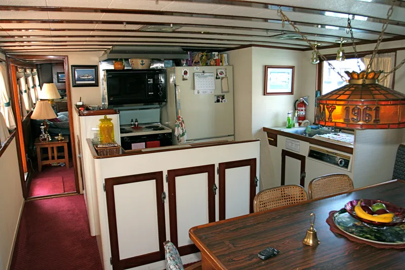 Slide: The Image of Interior of a classic yacht kitchen with wood details, built in 1946. - 34