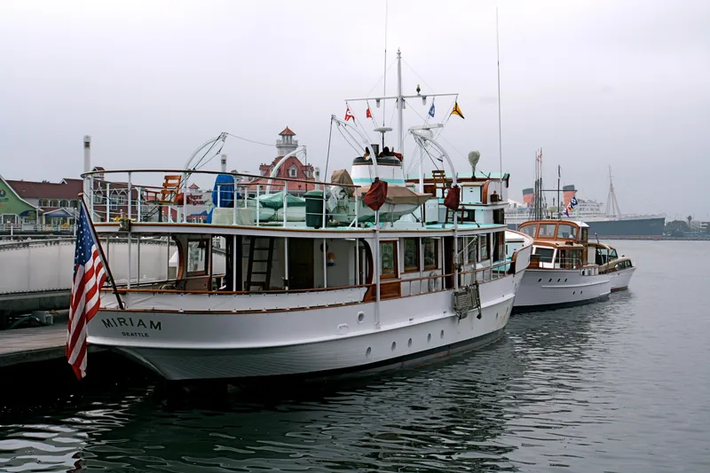 Slide: The Image of 1946 J.M. Martinac yacht docked, American flag displayed. - 8