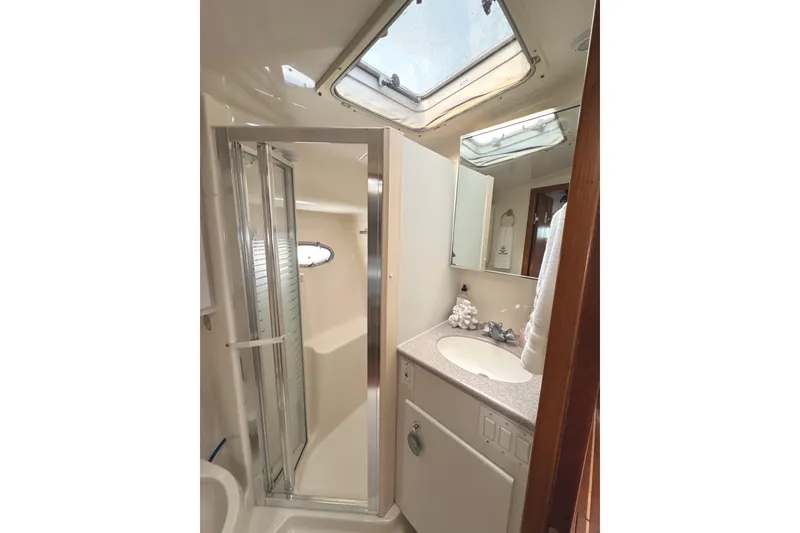 Slide: The Image of Bathroom interior of 1998 Tiara Yachts 4100 Open with shower and sink. - 12