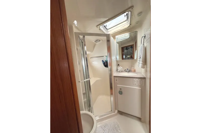 Slide: The Image of Bathroom interior of 1998 Tiara Yachts 4100 Open, featuring shower and vanity. - 13